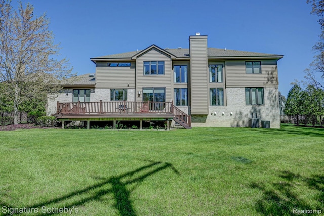 3225 Legacy Ct, West Bloomfield, MI 48323 - rear view of house with a chimney, a deck, and a yard