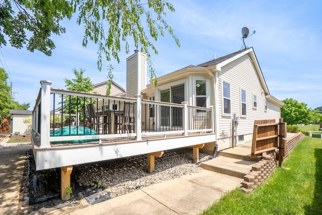4351 Knollcrest Dr, Ann Arbor, MI 48108 - back of property featuring a wooden deck and a chimney