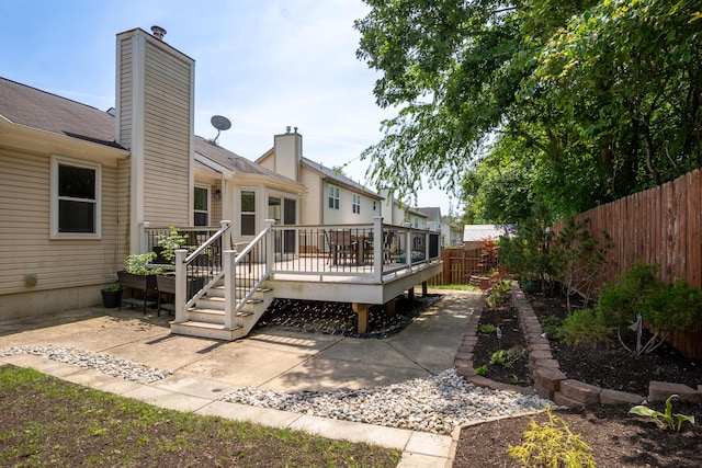 4351 Knollcrest Dr, Ann Arbor, MI 48108 - rear view of property featuring a fenced backyard, a chimney, a deck, and a patio area