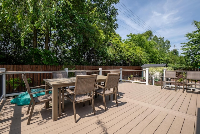 4351 Knollcrest Dr, Ann Arbor, MI 48108 - deck featuring outdoor dining area, a fenced backyard, and an outbuilding