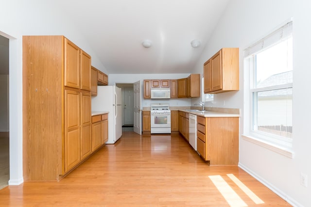 4351 Knollcrest Dr, Ann Arbor, MI 48108 - kitchen featuring white appliances, vaulted ceiling, light wood-style flooring, light countertops, and plenty of natural light