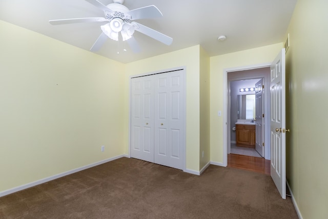 4351 Knollcrest Dr, Ann Arbor, MI 48108 - unfurnished bedroom with dark carpet, a closet, and ceiling fan