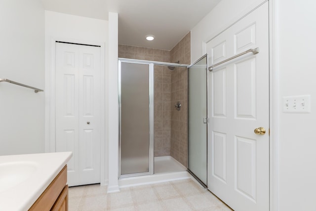4351 Knollcrest Dr, Ann Arbor, MI 48108 - bathroom featuring a stall shower, vanity, tile patterned floors, and a closet