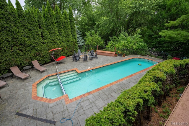 4683 Maura Ln, West Bloomfield, MI 48323 - view of pool with a patio area, an outdoor fire pit, and a pool with connected hot tub