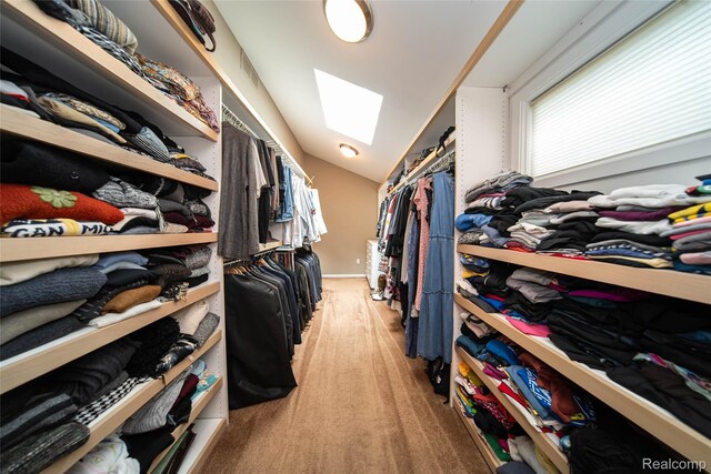 4683 Maura Ln, West Bloomfield, MI 48323 - walk in closet featuring lofted ceiling, light carpet, and a skylight