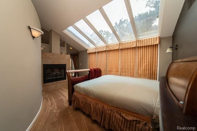 4683 Maura Ln, West Bloomfield, MI 48323 - carpeted bedroom with a skylight, lofted ceiling, and a tile fireplace