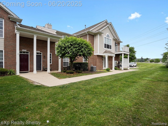 16436 Grandview Dr, Macomb, MI 48044 - view of front facade with brick siding, a front yard, and a chimney