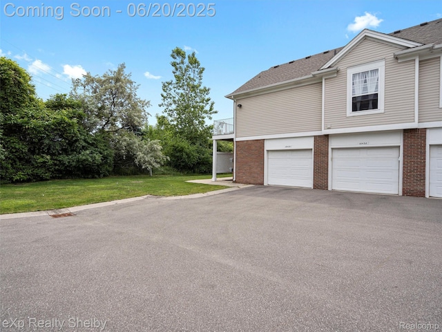 16436 Grandview Dr, Macomb, MI 48044 - view of home's exterior featuring brick siding, a lawn, a garage, and asphalt driveway