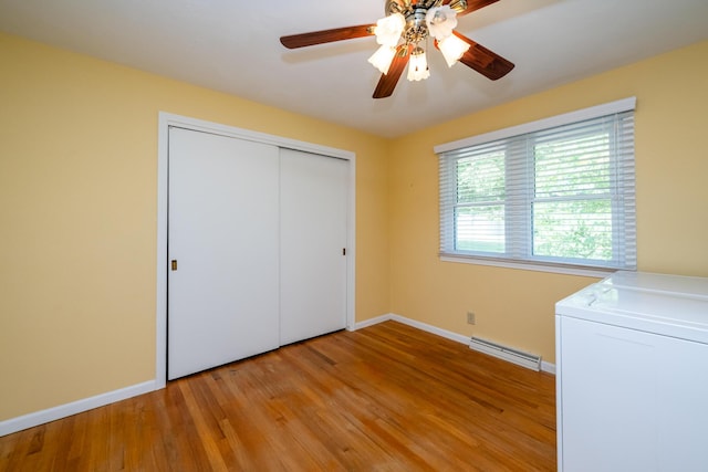 2729 Horton Ct, Niles, MI 49120 - unfurnished bedroom featuring washer / clothes dryer, light wood-type flooring, a closet, and ceiling fan