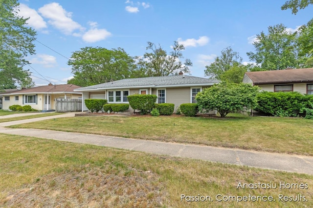 4516 Burgis Ave SE, Grand Rapids, MI 49508 - ranch-style home with concrete driveway and a chimney