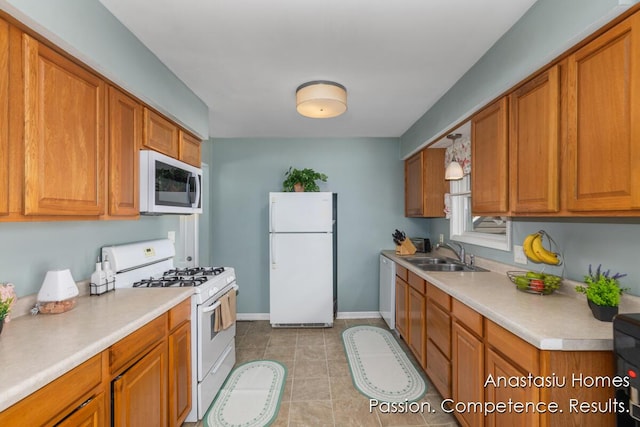 4516 Burgis Ave SE, Grand Rapids, MI 49508 - kitchen with white appliances, light countertops, brown cabinetry, and light tile patterned floors