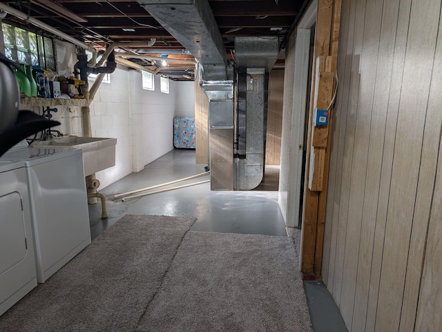 4516 Burgis Ave SE, Grand Rapids, MI 49508 - basement with washing machine and clothes dryer, wood walls, concrete block wall, and heating unit