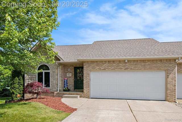 6073 Belmont Ct E, Grand Blanc, MI 48439 - view of front facade featuring a shingled roof, brick siding, and driveway