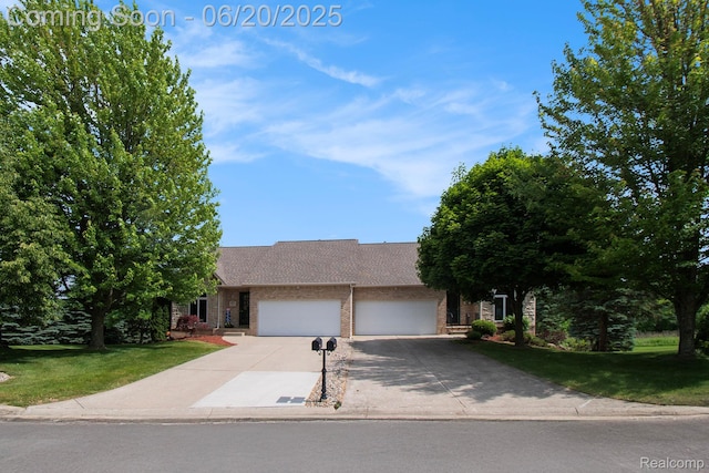 6073 Belmont Ct E, Grand Blanc, MI 48439 - view of front of home with brick siding, an attached garage, concrete driveway, and a front lawn