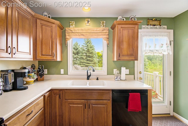 6073 Belmont Ct E, Grand Blanc, MI 48439 - kitchen with black dishwasher, light countertops, and brown cabinetry