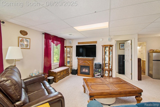 6073 Belmont Ct E, Grand Blanc, MI 48439 - living room featuring a paneled ceiling, carpet floors, and a glass covered fireplace