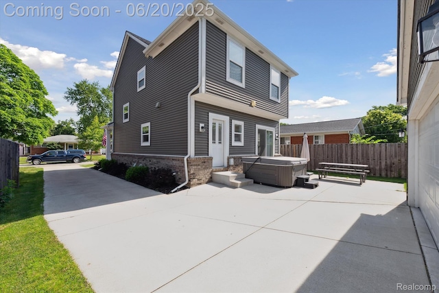 1920 Rowland Ave, Royal Oak, MI 48067 - back of house featuring a hot tub, brick siding, and a patio area