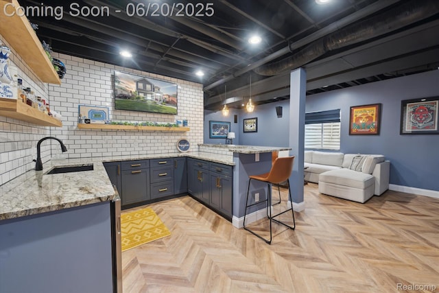 1920 Rowland Ave, Royal Oak, MI 48067 - kitchen with open shelves, a breakfast bar, light stone countertops, a peninsula, and tasteful backsplash