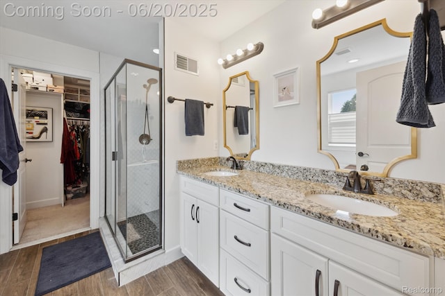 1920 Rowland Ave, Royal Oak, MI 48067 - full bathroom with a shower stall, double vanity, a spacious closet, and wood finished floors