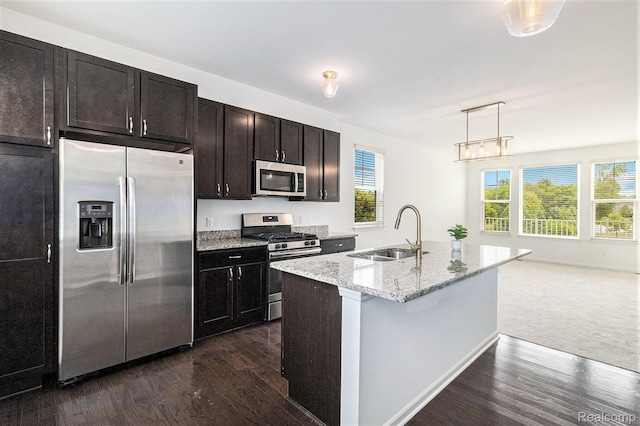 478 N Wixom Rd, Wixom, MI 48393 - kitchen with stainless steel appliances, dark wood-style floors, light stone countertops, and pendant lighting