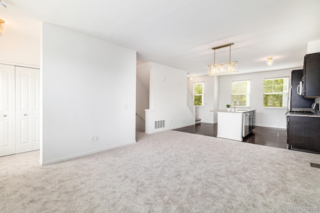 478 N Wixom Rd, Wixom, MI 48393 - kitchen featuring dark colored carpet, pendant lighting, fridge, open floor plan, and stainless steel dishwasher