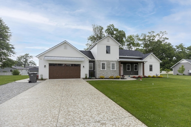 21536 Fieldview Dr, Edwardsburg, MI 49112 - modern farmhouse featuring concrete driveway, a front yard, a garage, board and batten siding, and stone siding