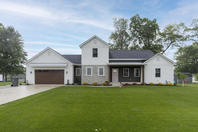 21536 Fieldview Dr, Edwardsburg, MI 49112 - modern farmhouse with driveway, a front yard, a garage, and stone siding