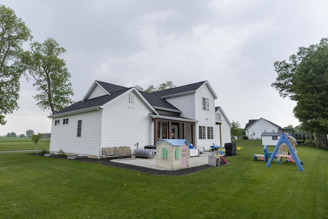 21536 Fieldview Dr, Edwardsburg, MI 49112 - back of house featuring a playground, a patio area, and a lawn
