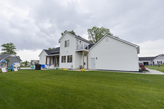 21536 Fieldview Dr, Edwardsburg, MI 49112 - back of property featuring a balcony, a yard, and a patio area