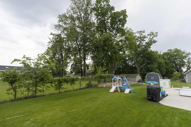 21536 Fieldview Dr, Edwardsburg, MI 49112 - view of yard featuring a playground and a storage unit