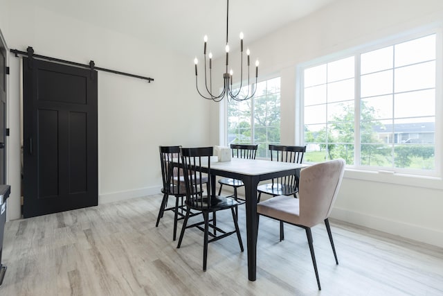 21536 Fieldview Dr, Edwardsburg, MI 49112 - dining room featuring healthy amount of natural light, light wood-style flooring, a barn door, and a chandelier