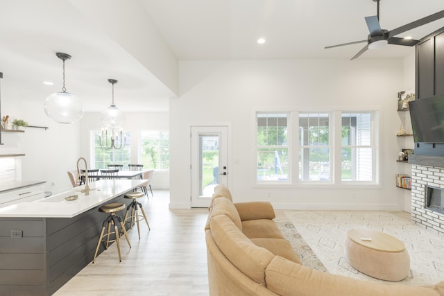 21536 Fieldview Dr, Edwardsburg, MI 49112 - living room featuring a ceiling fan, plenty of natural light, light wood-style flooring, a brick fireplace, and recessed lighting