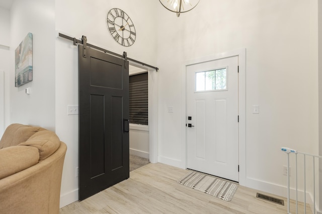 21536 Fieldview Dr, Edwardsburg, MI 49112 - foyer entrance featuring a barn door and wood finished floors
