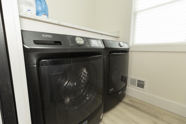 21536 Fieldview Dr, Edwardsburg, MI 49112 - laundry room featuring washing machine and clothes dryer and wood finished floors