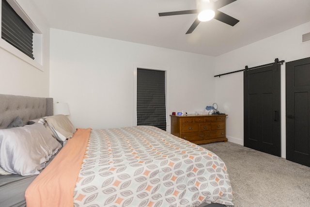 21536 Fieldview Dr, Edwardsburg, MI 49112 - bedroom featuring a barn door, carpet flooring, and ceiling fan