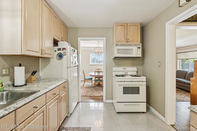 1972 Theodore St, Trenton, MI 48183 - kitchen featuring white appliances, light brown cabinets, tasteful backsplash, and a chandelier