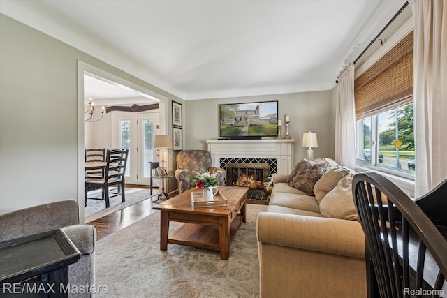 1972 Theodore St, Trenton, MI 48183 - living room featuring a tiled fireplace, wood finished floors, and a chandelier