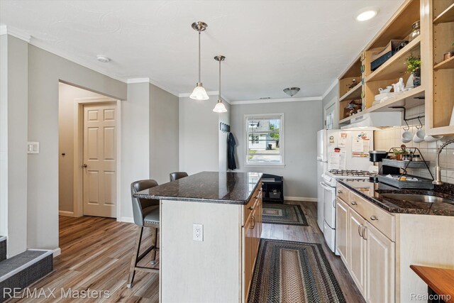 1972 Theodore St, Trenton, MI 48183 - kitchen featuring white gas stove, a kitchen bar, dark wood-style floors, a kitchen island, and open shelves