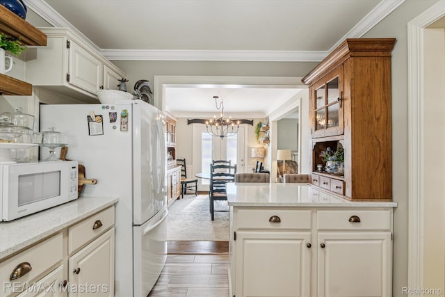 1972 Theodore St, Trenton, MI 48183 - kitchen featuring white appliances, a chandelier, open shelves, crown molding, and light stone counters