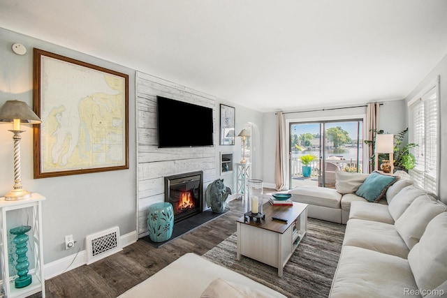 11501 Torrey Rd, Fenton, MI 48430 - living area with dark wood-style flooring and a stone fireplace