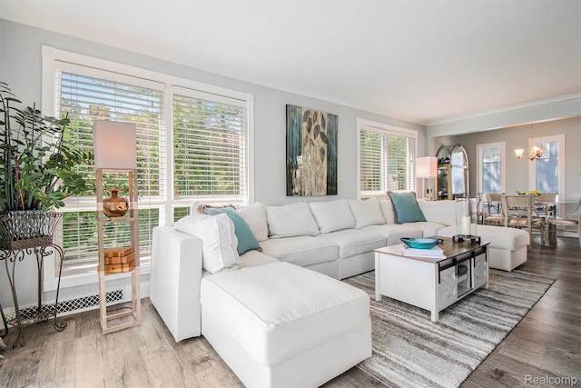 11501 Torrey Rd, Fenton, MI 48430 - living room featuring a chandelier, plenty of natural light, and wood finished floors