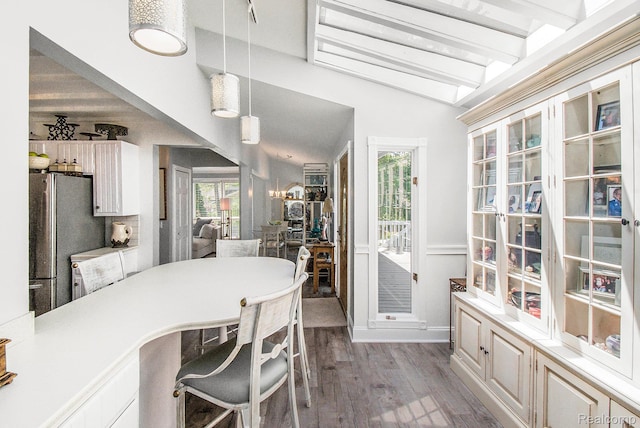 11501 Torrey Rd, Fenton, MI 48430 - dining area featuring plenty of natural light, wood finished floors, and vaulted ceiling