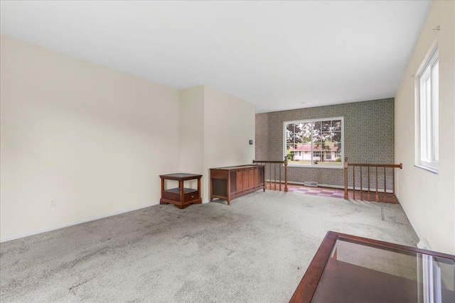 360 Wood Creek Dr, Howell, MI 48843 - carpeted empty room featuring healthy amount of natural light and wallpapered walls