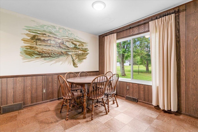 360 Wood Creek Dr, Howell, MI 48843 - dining room with wooden walls, a wainscoted wall, and light floors
