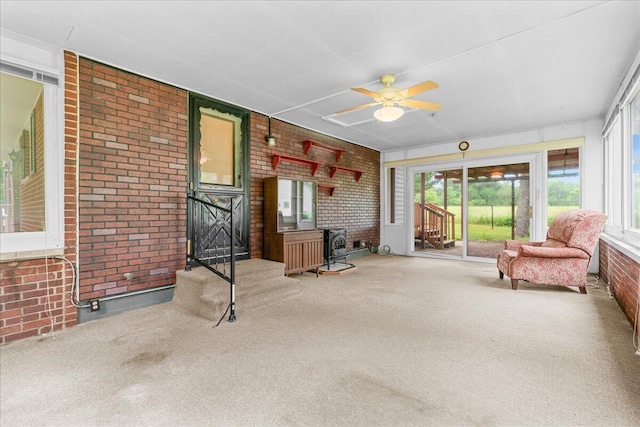 360 Wood Creek Dr, Howell, MI 48843 - sunroom / solarium with brick wall, carpet, and a wood stove