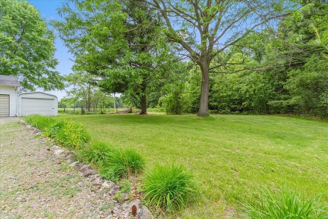 360 Wood Creek Dr, Howell, MI 48843 - view of grassy yard with an outbuilding and a garage