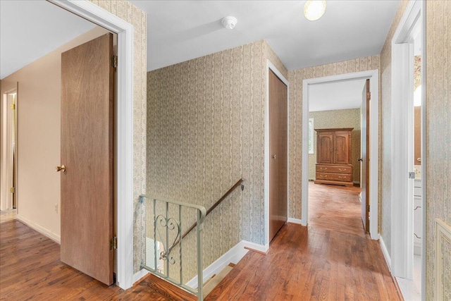 360 Wood Creek Dr, Howell, MI 48843 - hall featuring an upstairs landing, wallpapered walls, and wood finished floors