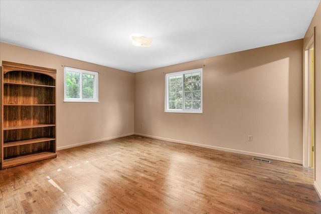 360 Wood Creek Dr, Howell, MI 48843 - unfurnished room featuring healthy amount of natural light and wood finished floors