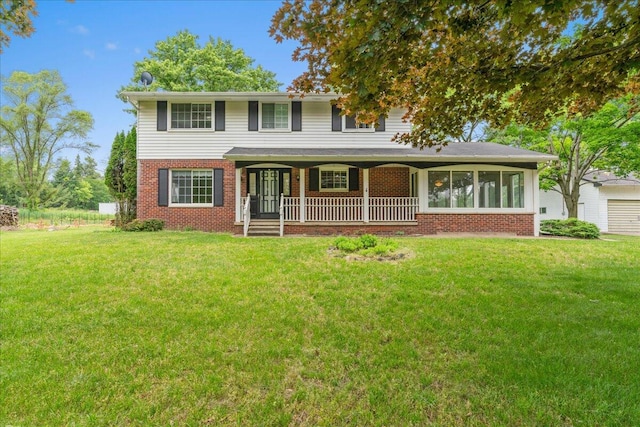 360 Wood Creek Dr, Howell, MI 48843 - traditional-style house with brick siding, a porch, and a front yard