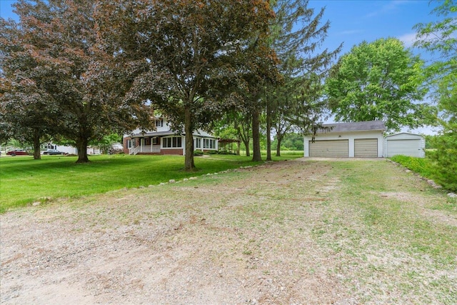 360 Wood Creek Dr, Howell, MI 48843 - view of green lawn with an outbuilding and a garage